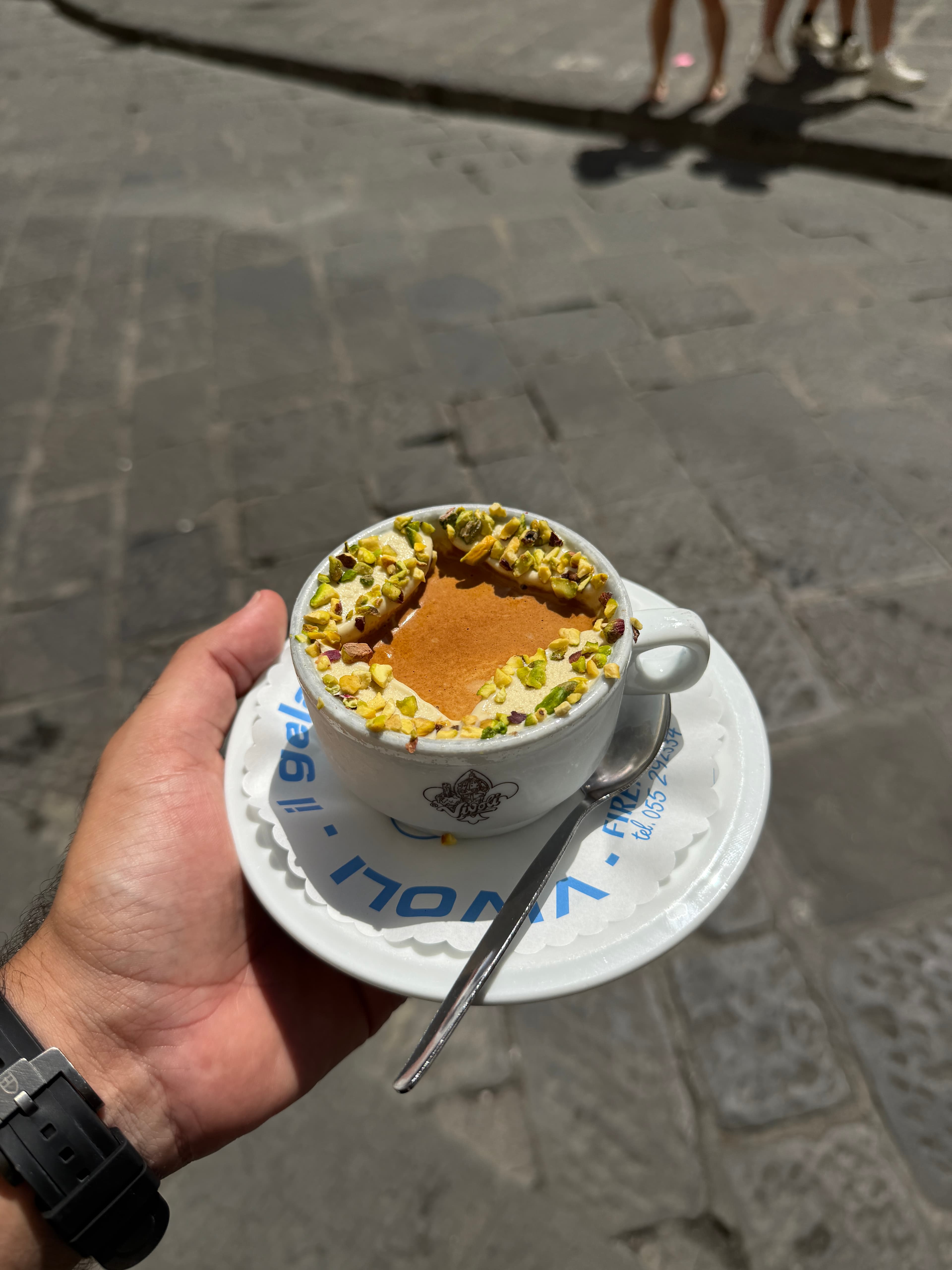 Affogato with pistachios at Vivoli, held on a sunlit Florence street