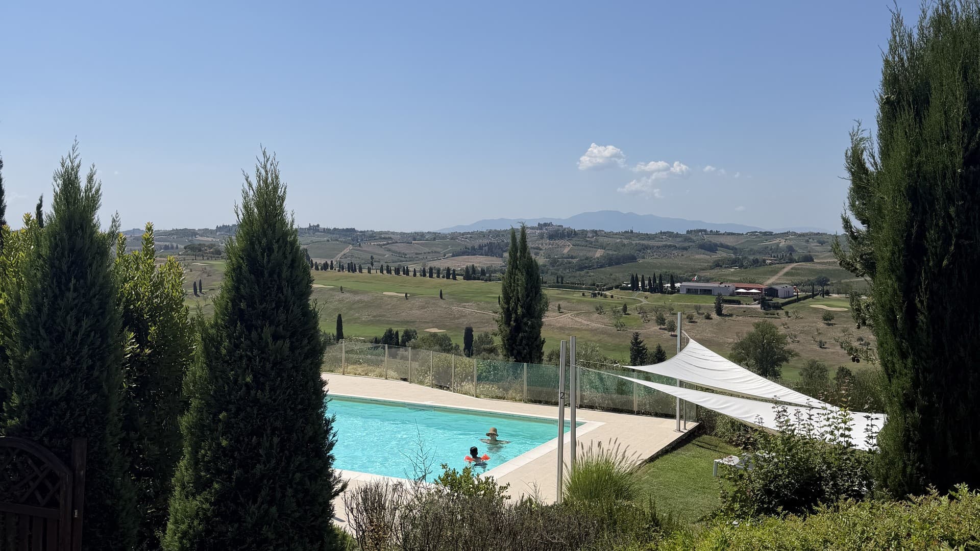 The saltwater pool at Casetta Prima held between cypresses, the Vinci valley opening beyond