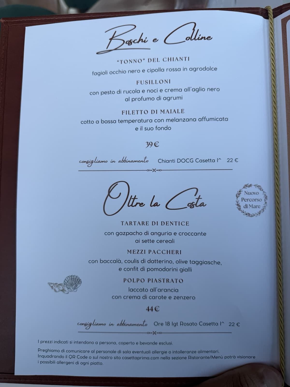 The Boschi e Colline tasting menu at 39 euro with a suggested Chianti pairing at 22 euro, and below it the seafood menu Oltre la Costa at 44 euro with a Rosato pairing at 22 euro