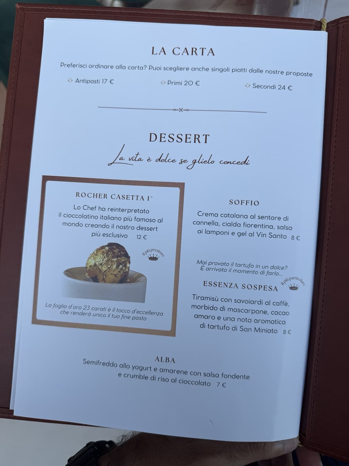 The a la carte page, antipasti 17 euro, primi 20 euro, secondi 24 euro, above a dessert list including the gold-leafed Rocher Casetta I^ at 12 euro