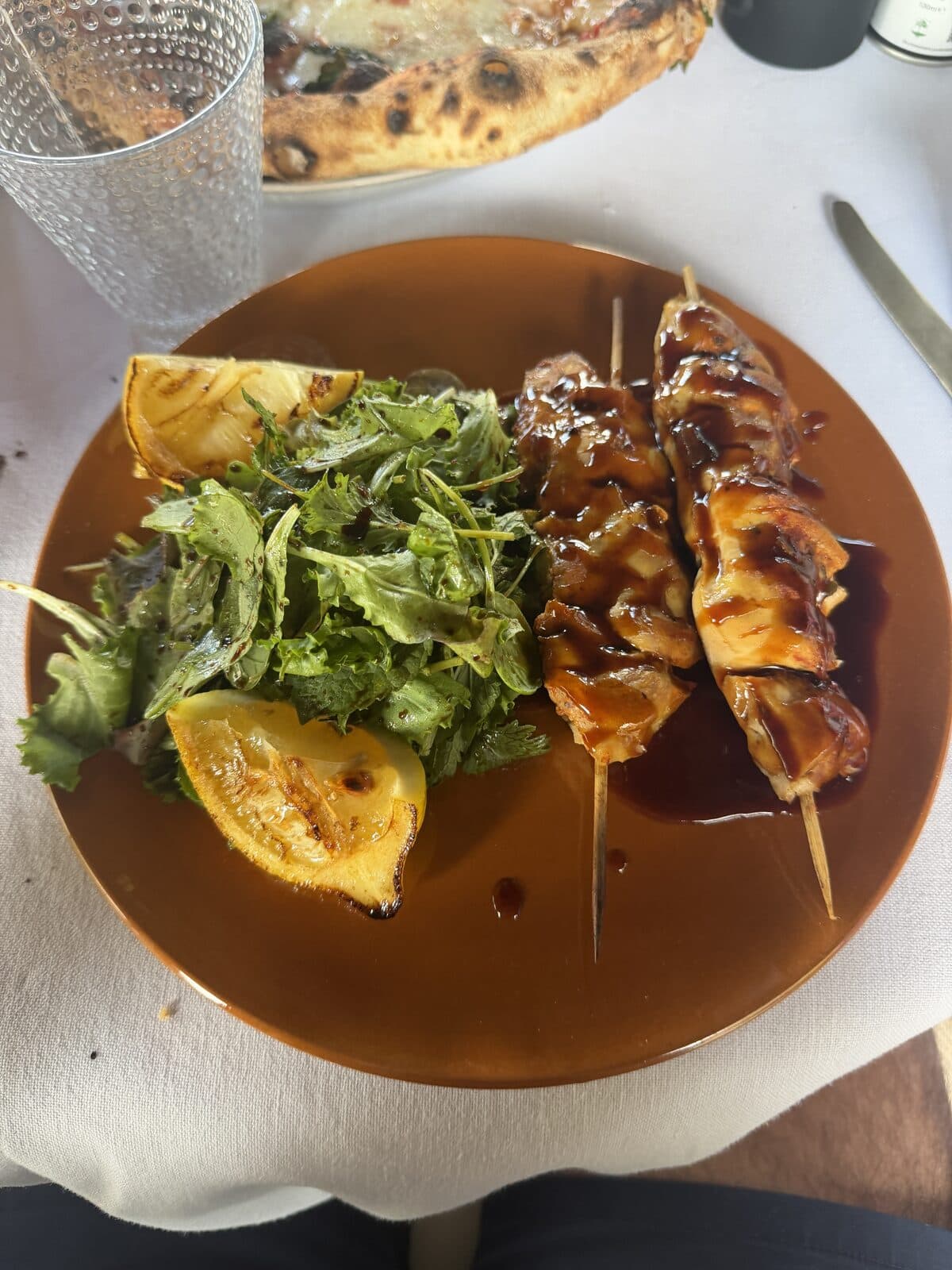 Grilled skewers with salad and charred lemon at the pool restaurant
