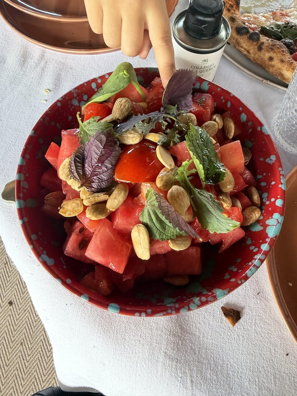 Watermelon summer salad with almonds and herbs at the pool restaurant