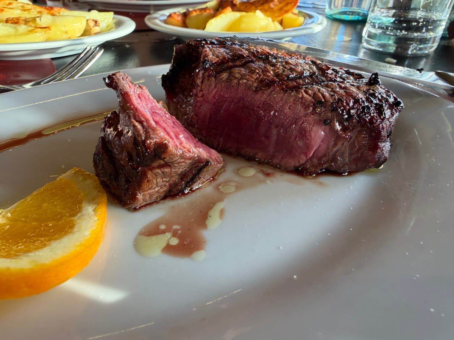 Grilled veal filet, cut open, with an orange slice