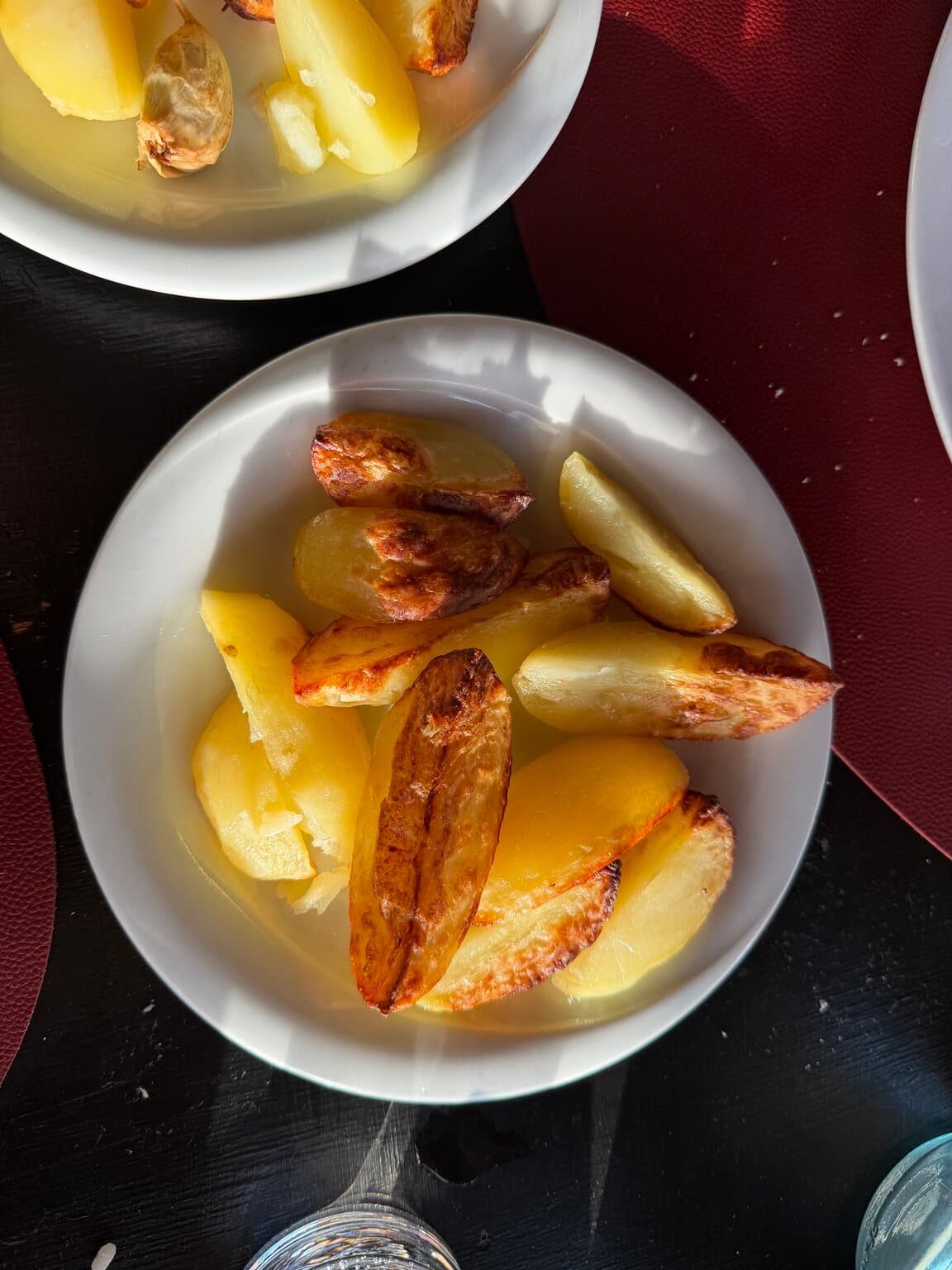 A plate of oven-roasted potato wedges