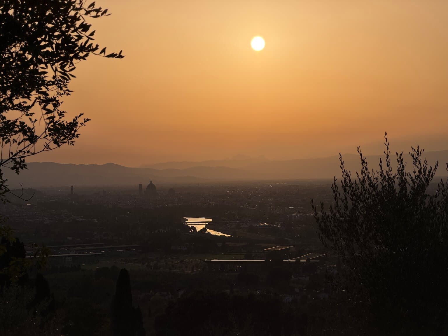 Sunset view over Florence with the Duomo visible in the distance, seen from the road below La Gargotta
